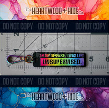 Load image into Gallery viewer, Color Printed Bag Charms - In My Defense, I Was Left Unsupervised. - Matte Black Acrylic